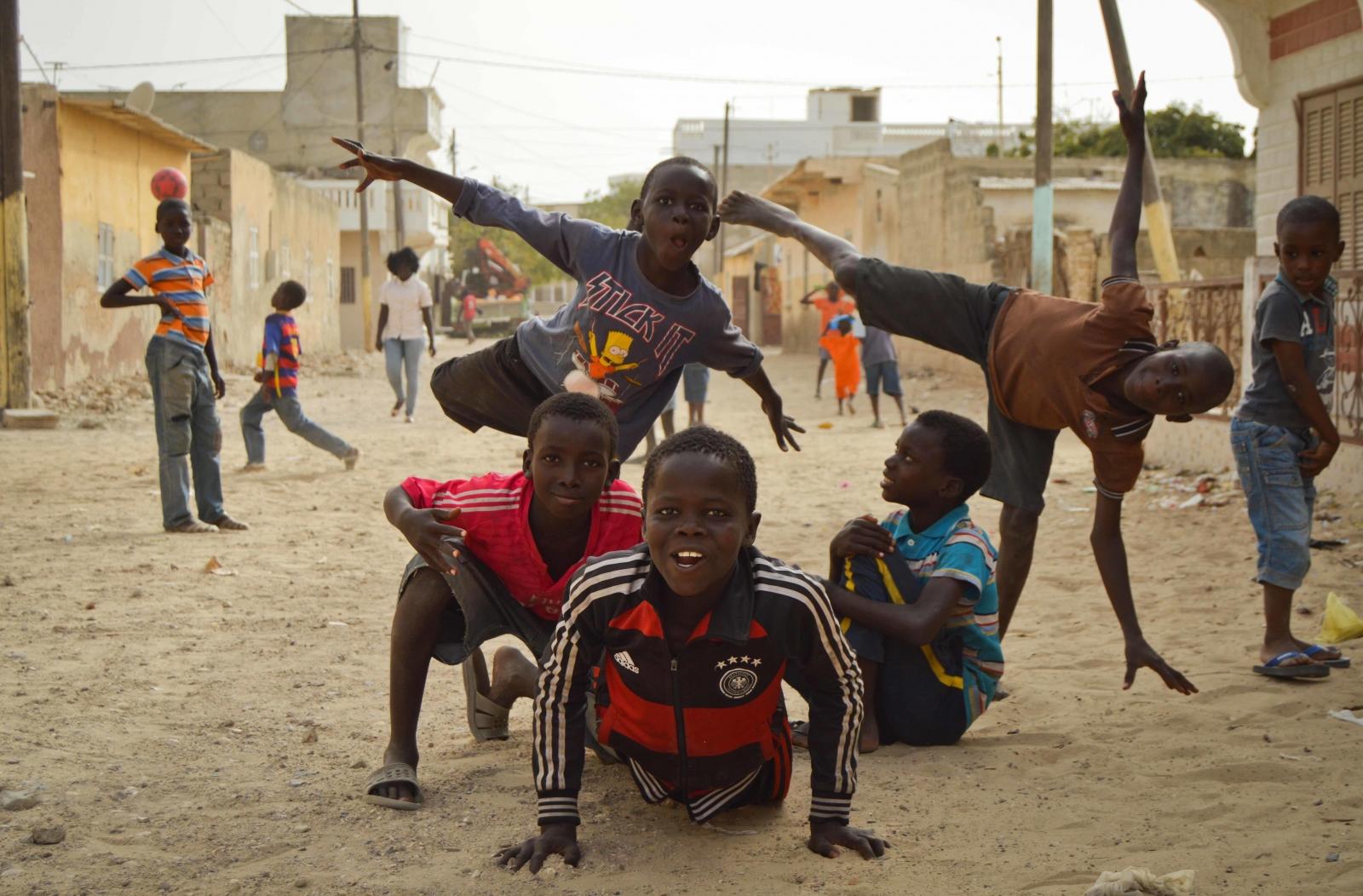 Talibe children play in the streets of dusty St. Louis in Senegal. Talibe children play in the streets of dusty St. Louis in Senegal.